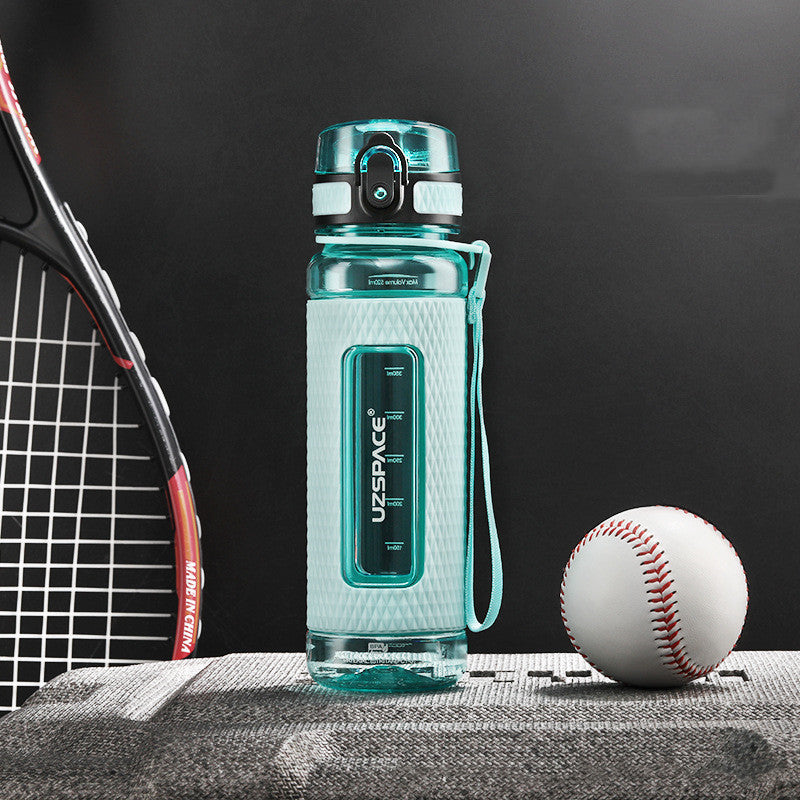Teal water bottle with a black background, tennis racket, and baseball on a table.